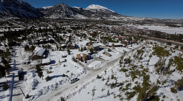 snowy aerial view with a residential view and a mountain view