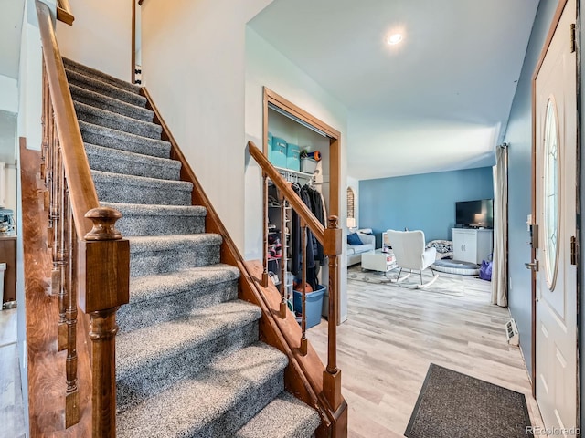 stairs featuring wood finished floors