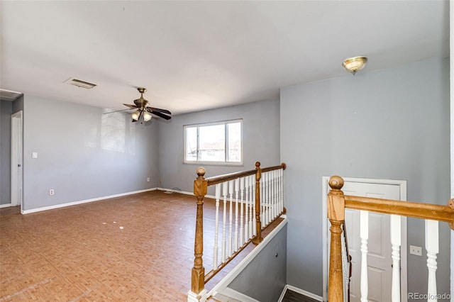 interior space with ceiling fan