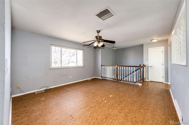 spare room with hardwood / wood-style floors and ceiling fan