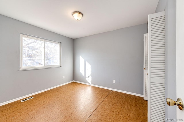 unfurnished bedroom featuring hardwood / wood-style flooring and a closet