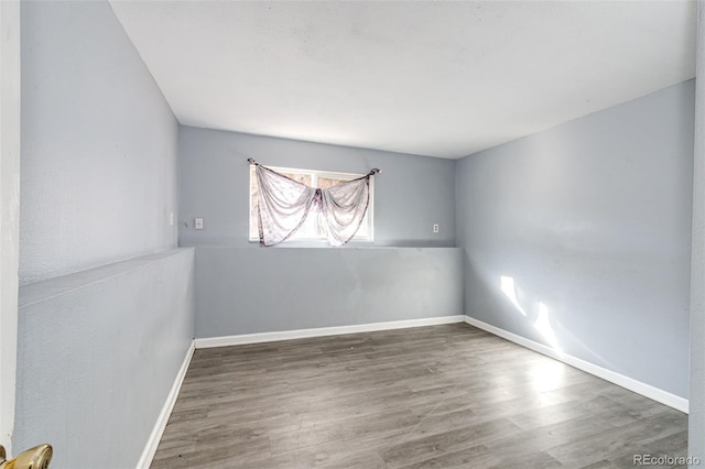 empty room featuring dark wood-type flooring