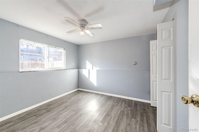 spare room featuring ceiling fan and dark hardwood / wood-style floors