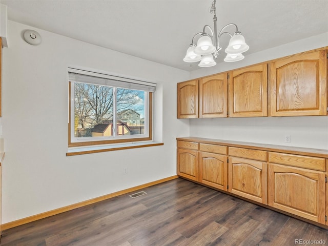 kitchen featuring dark hardwood / wood-style floors, hanging light fixtures, and a notable chandelier