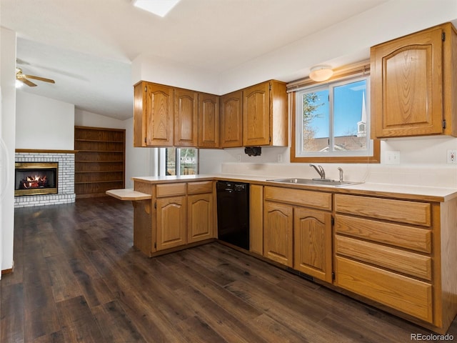 kitchen with dark hardwood / wood-style floors, sink, kitchen peninsula, and black dishwasher