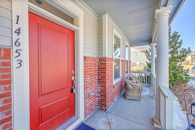 doorway to property featuring covered porch