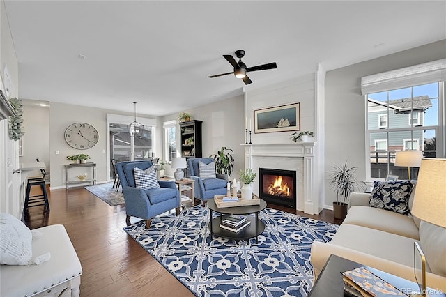 living room with ceiling fan, dark hardwood / wood-style floors, and a wealth of natural light