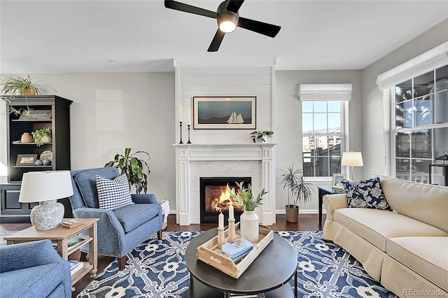 living room featuring dark wood-type flooring and ceiling fan