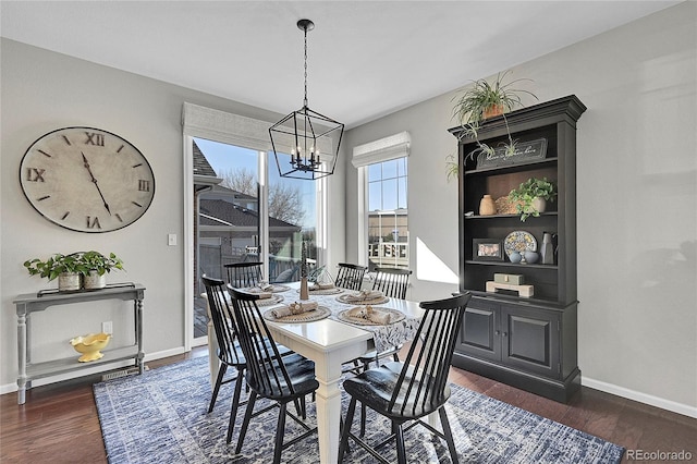 dining space featuring an inviting chandelier and dark wood-type flooring