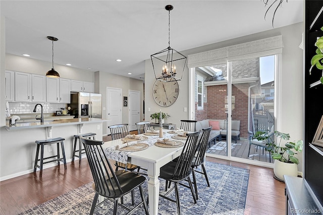 dining room with an inviting chandelier and dark hardwood / wood-style flooring