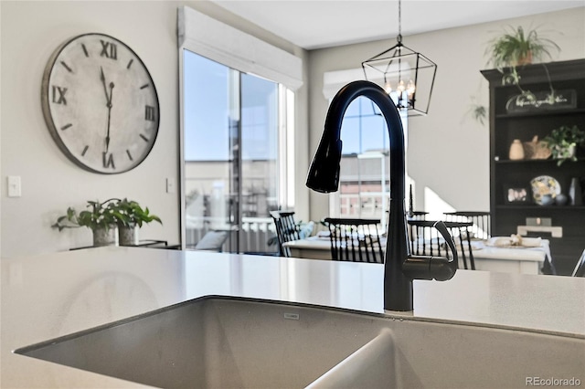 kitchen featuring pendant lighting and a chandelier