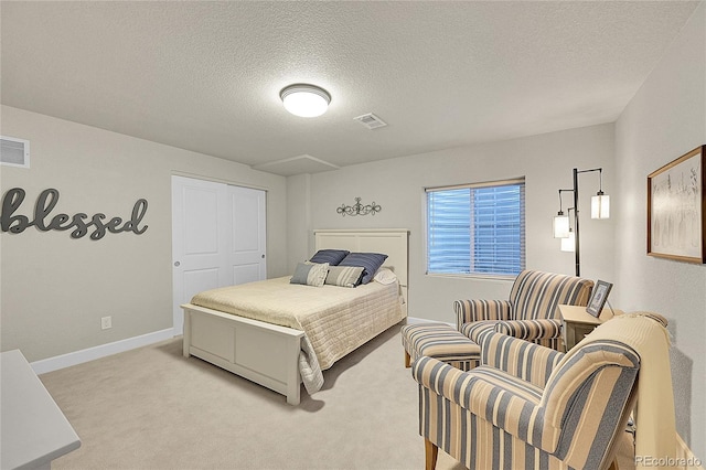 carpeted bedroom with a textured ceiling