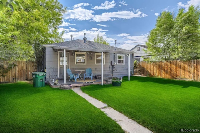 rear view of property featuring a yard