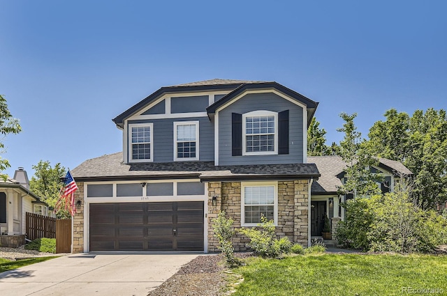 9545 Grand Cypress Cv, Lone Tree, CO 80124 - view of front of home with concrete driveway, stone siding, roof with shingles, and an attached garage