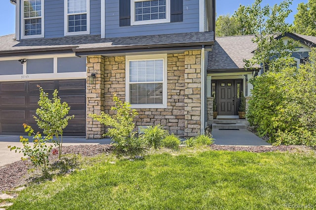 9545 Grand Cypress Cv, Lone Tree, CO 80124 - view of front of property featuring stone siding, a shingled roof, a front yard, and a garage