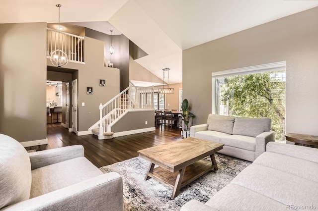 9545 Grand Cypress Cv, Lone Tree, CO 80124 - living area with a chandelier, wood finished floors, high vaulted ceiling, baseboards, and stairs
