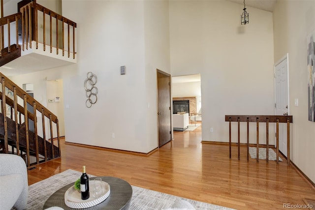 living room featuring a towering ceiling and hardwood / wood-style flooring