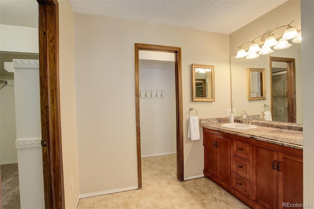 bathroom with a textured ceiling and vanity