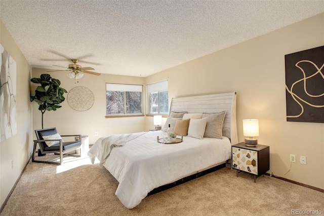 carpeted bedroom with ceiling fan and a textured ceiling