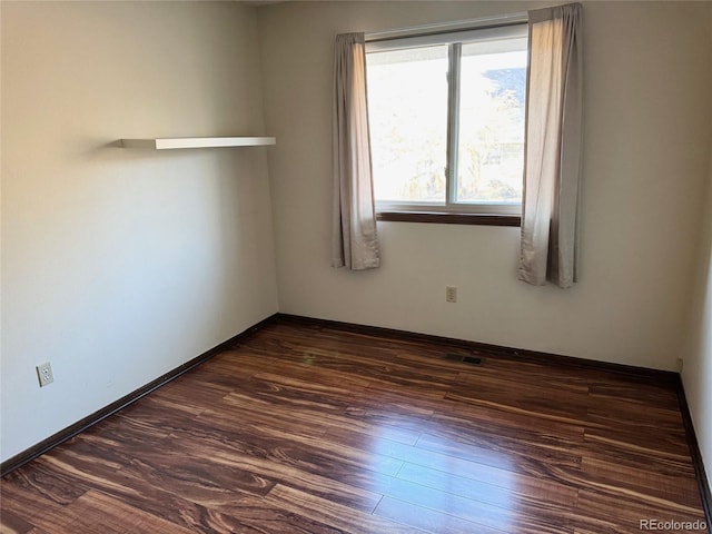 unfurnished room with dark hardwood / wood-style floors