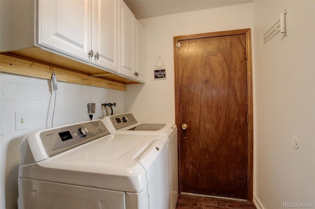 clothes washing area with cabinets and separate washer and dryer