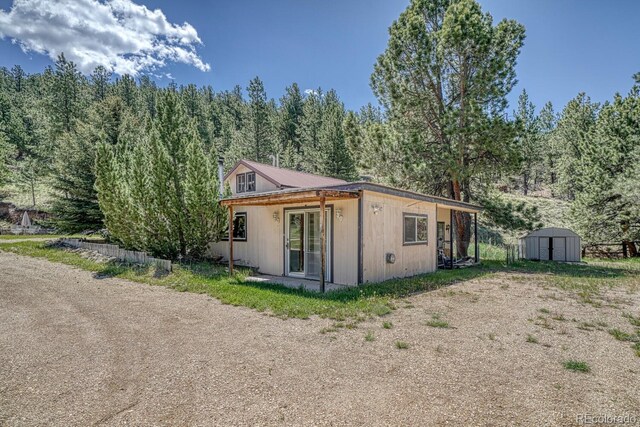 6130 County Road 328, Westcliffe, CO 81252 - view of front facade featuring a shed and a forest view