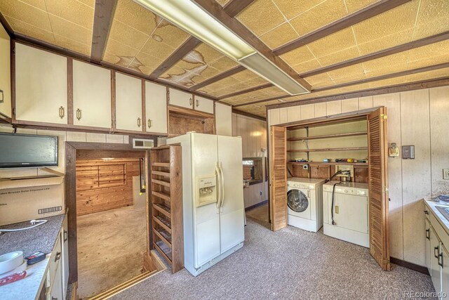6130 County Road 328, Westcliffe, CO 81252 - laundry area with washing machine and dryer, light carpet, and wood walls