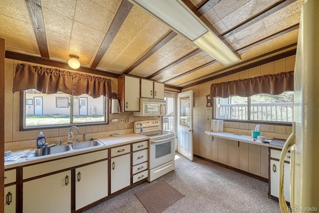 6130 County Road 328, Westcliffe, CO 81252 - kitchen featuring white appliances, light countertops, wooden walls, and light carpet