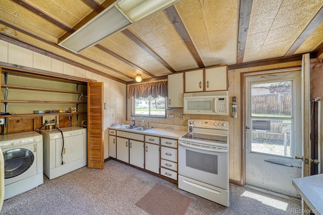 6130 County Road 328, Westcliffe, CO 81252 - kitchen featuring white appliances, washer and dryer, light countertops, wooden walls, and white cabinets