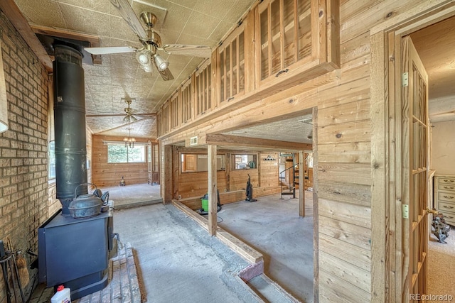 6130 County Road 328, Westcliffe, CO 81252 - interior space featuring a wood stove, wooden walls, and ceiling fan