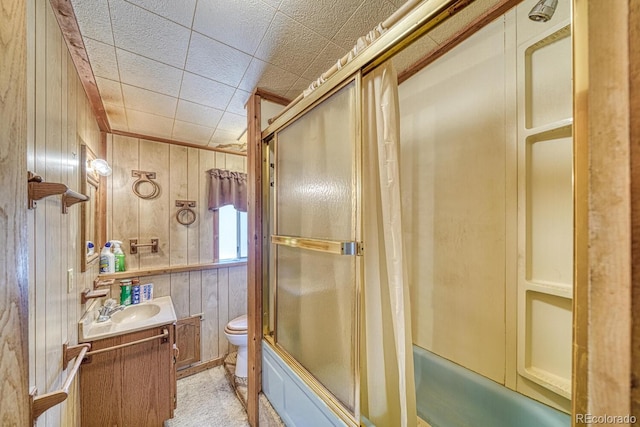 6130 County Road 328, Westcliffe, CO 81252 - full bathroom featuring vanity, shower / bath combination with glass door, and wood walls