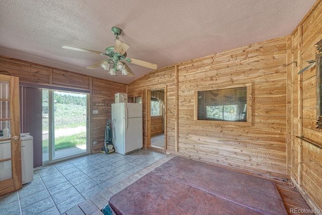 6130 County Road 328, Westcliffe, CO 81252 - unfurnished room featuring wooden walls, vaulted ceiling, plenty of natural light, a ceiling fan, and a textured ceiling