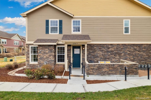 craftsman-style home featuring stone siding