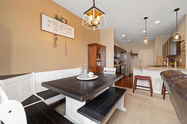 dining space with light carpet, recessed lighting, and a notable chandelier
