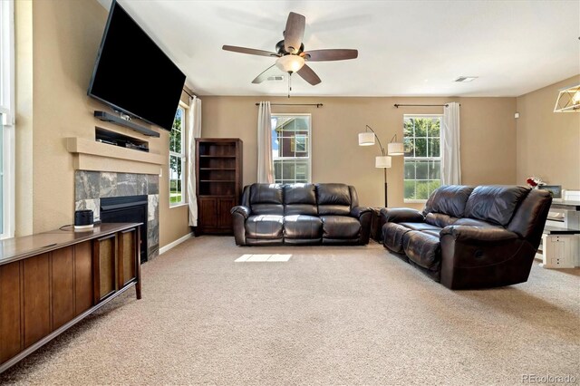 12744 Leyden St Unit F, Thornton, CO 80602 - living area with light colored carpet, plenty of natural light, a premium fireplace, and a ceiling fan