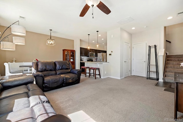 12744 Leyden St Unit F, Thornton, CO 80602 - living area featuring light carpet, stairs, ceiling fan, and recessed lighting