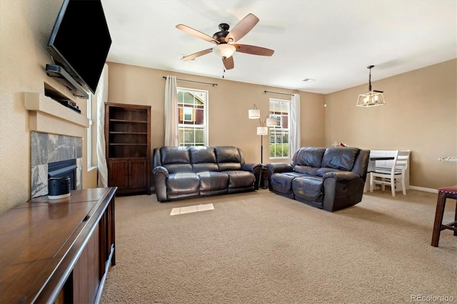 12744 Leyden St Unit F, Thornton, CO 80602 - living area featuring light carpet, a premium fireplace, and a ceiling fan