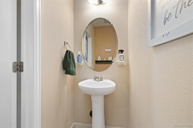 12744 Leyden St Unit F, Thornton, CO 80602 - bathroom featuring a textured wall and a sink