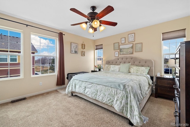 12744 Leyden St Unit F, Thornton, CO 80602 - carpeted bedroom featuring multiple windows and ceiling fan