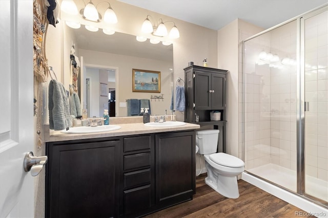 12744 Leyden St Unit F, Thornton, CO 80602 - bathroom with double vanity, a shower stall, and wood finished floors