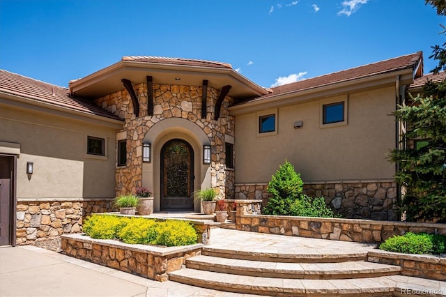 6194 Falcon Ridge Way, Morrison, CO 80465 - view of exterior entry with stone siding and stucco siding