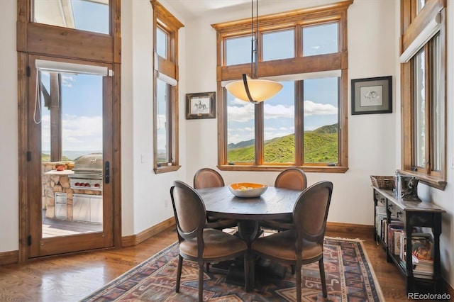 6194 Falcon Ridge Way, Morrison, CO 80465 - dining space with baseboards and dark wood finished floors