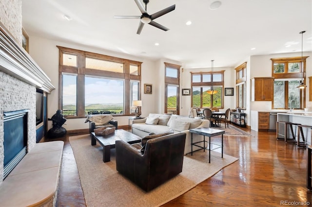 6194 Falcon Ridge Way, Morrison, CO 80465 - living room with a fireplace, a ceiling fan, recessed lighting, and dark wood-style flooring