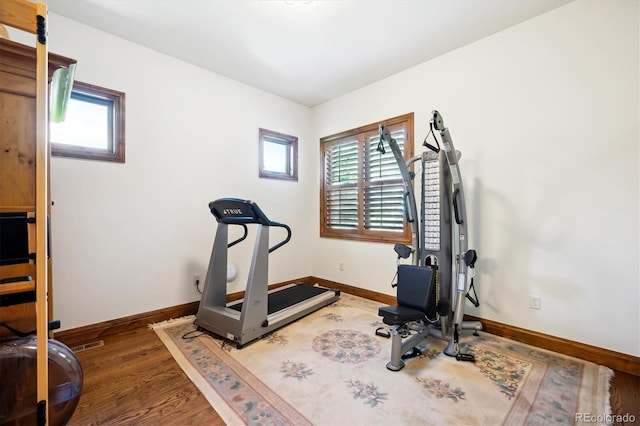 6194 Falcon Ridge Way, Morrison, CO 80465 - workout area with healthy amount of natural light, baseboards, and wood finished floors