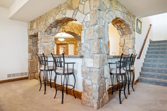 6194 Falcon Ridge Way, Morrison, CO 80465 - indoor bar with carpet floors, stairs, baseboards, and arched walkways