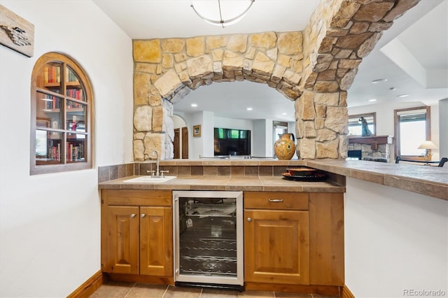 6194 Falcon Ridge Way, Morrison, CO 80465 - indoor wet bar with wine cooler, light tile patterned flooring, recessed lighting, and baseboards