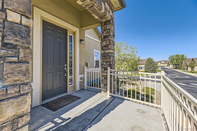 view of exterior entry featuring a porch