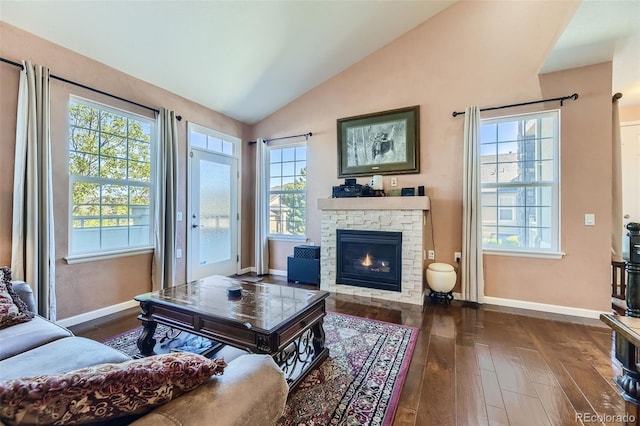 living room featuring a fireplace, dark hardwood / wood-style floors, and vaulted ceiling