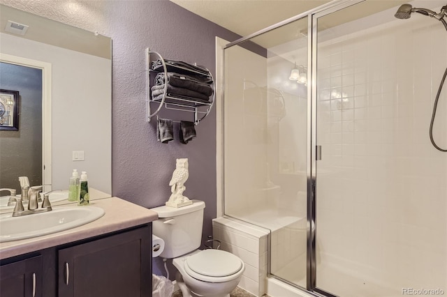 bathroom featuring vanity, toilet, and walk in shower