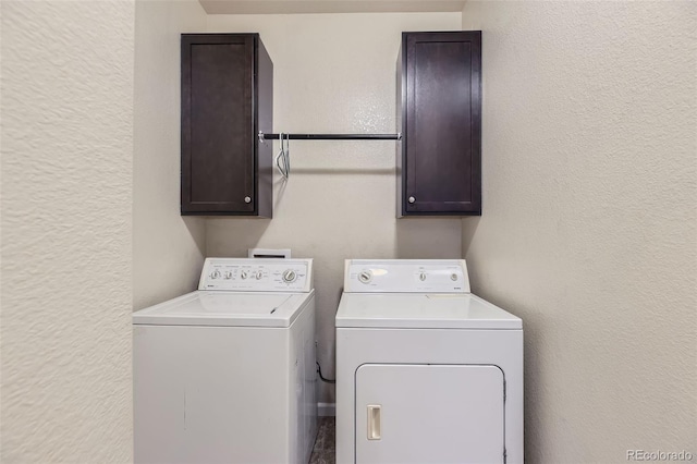 laundry area with separate washer and dryer and cabinets